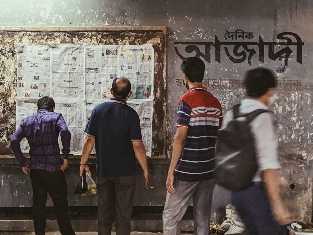 Editorial team reviewing a whiteboard with a news page hierarchy